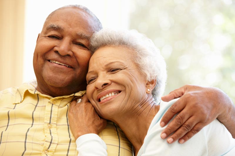 With faces filled with joy and love, the couple tightly embraces one another at the comfort of Anchor resident.
